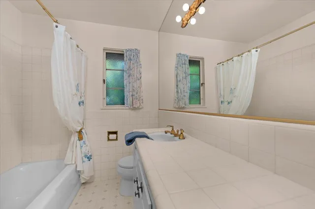 a view of a patio with couches chairs dining table and chairs with a barbeque grill