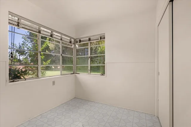 a view of a backyard with a swimming pool and lawn chairs