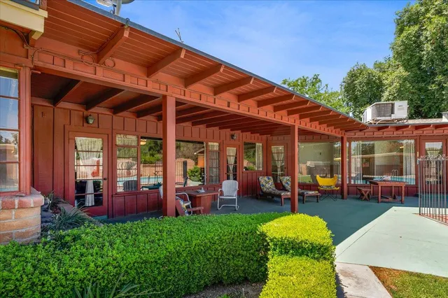 a view of a patio with table and chairs potted plants with wooden floor