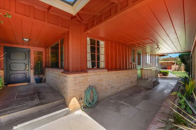 a view of a deck and a yard with green space