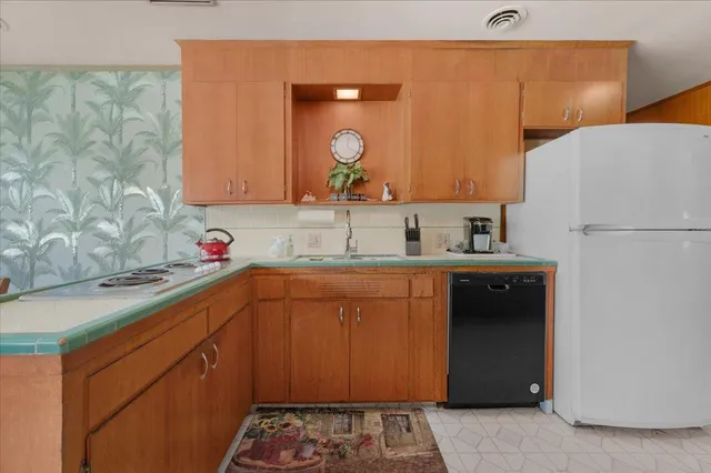 a view of a dining room with furniture and a potted plant