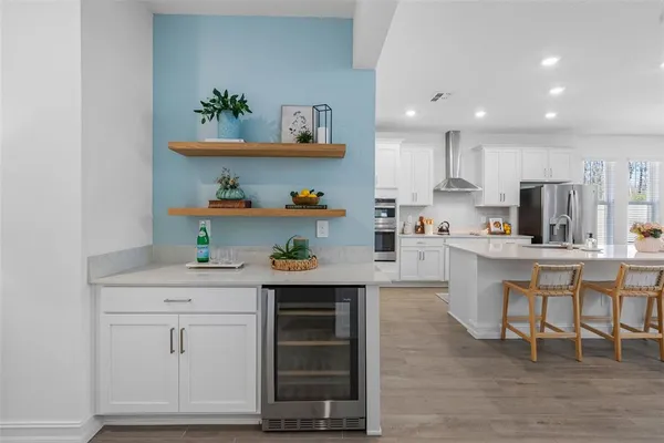 a kitchen with white cabinets and white appliances