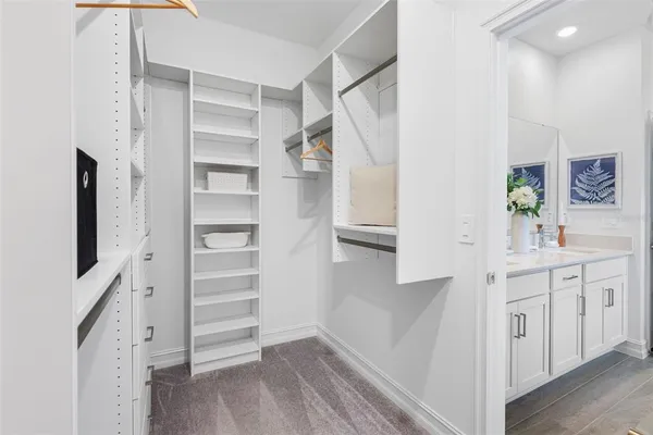a spacious en suite bathroom with a double sink and mirror