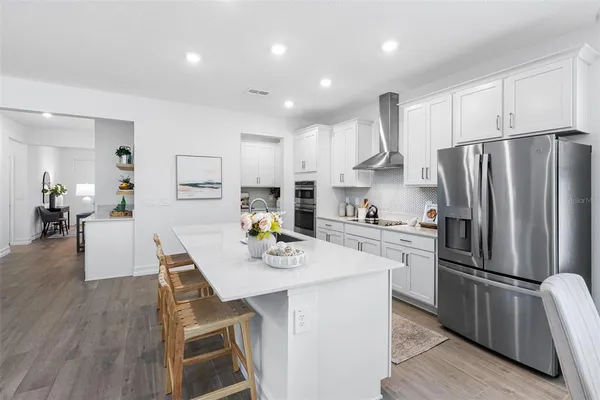 a kitchen with counter top space a sink a stove and cabinets