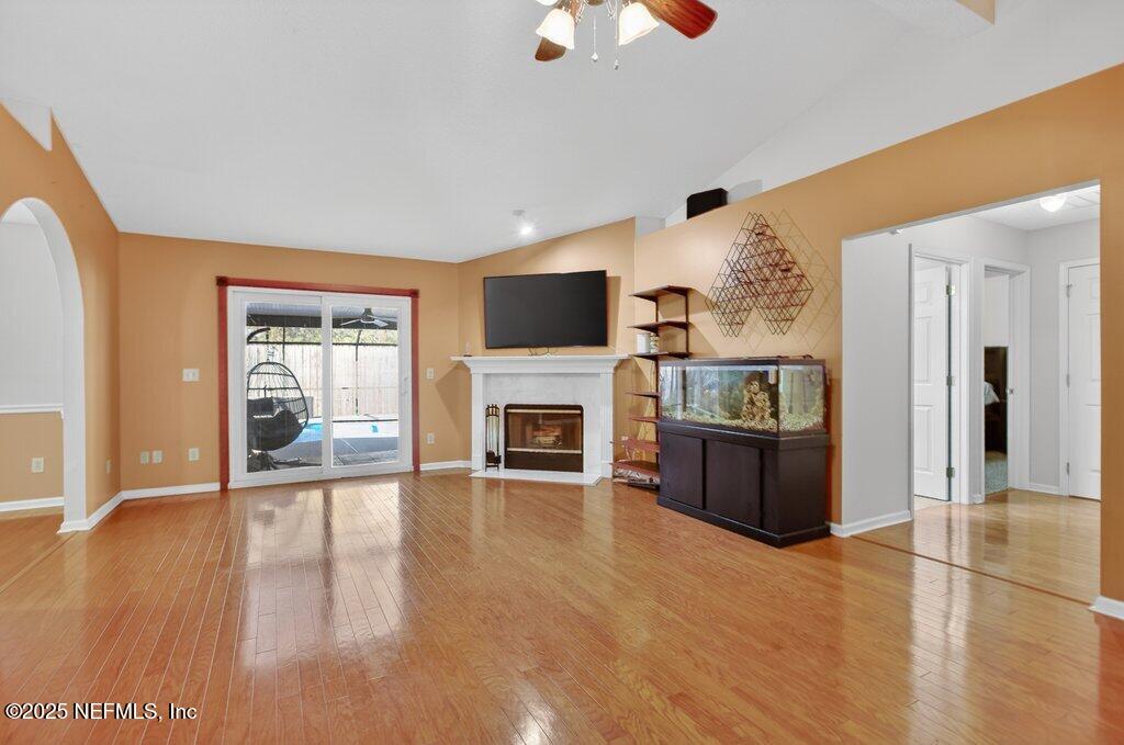 2472 Moon Harbor Way Middleburg, FL 32068 - Photo 13 of 52 a living room with furniture flat screen tv and a fireplace