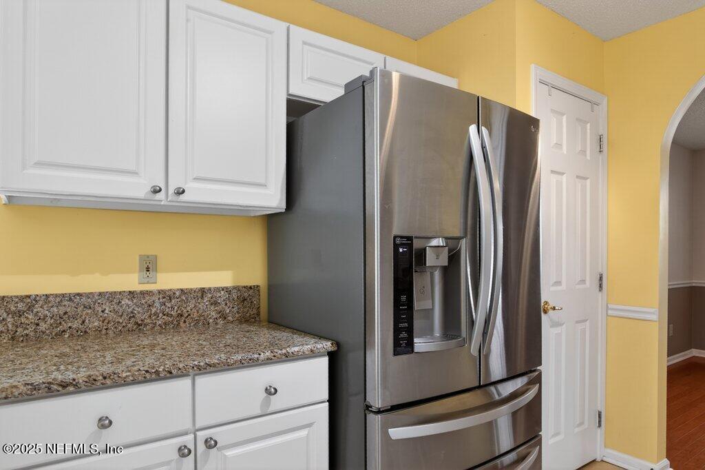 2472 Moon Harbor Way Middleburg, FL 32068 - Photo 15 of 52 a kitchen with granite countertop a refrigerator and a sink