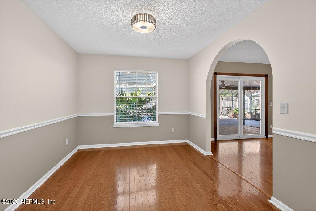2472 Moon Harbor Way Middleburg, FL 32068 - Photo 27 of 52 an empty room with wooden floor and windows