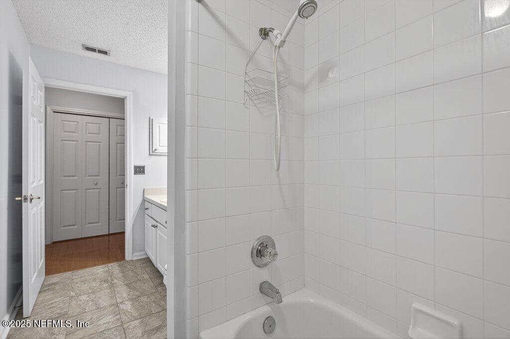 2472 Moon Harbor Way Middleburg, FL 32068 - Photo 31 of 52 a bathroom with a bathtub and shower