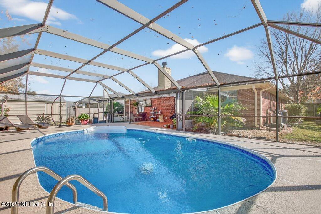 2472 Moon Harbor Way Middleburg, FL 32068 - Photo 40 of 52 a view of a swimming pool with a patio