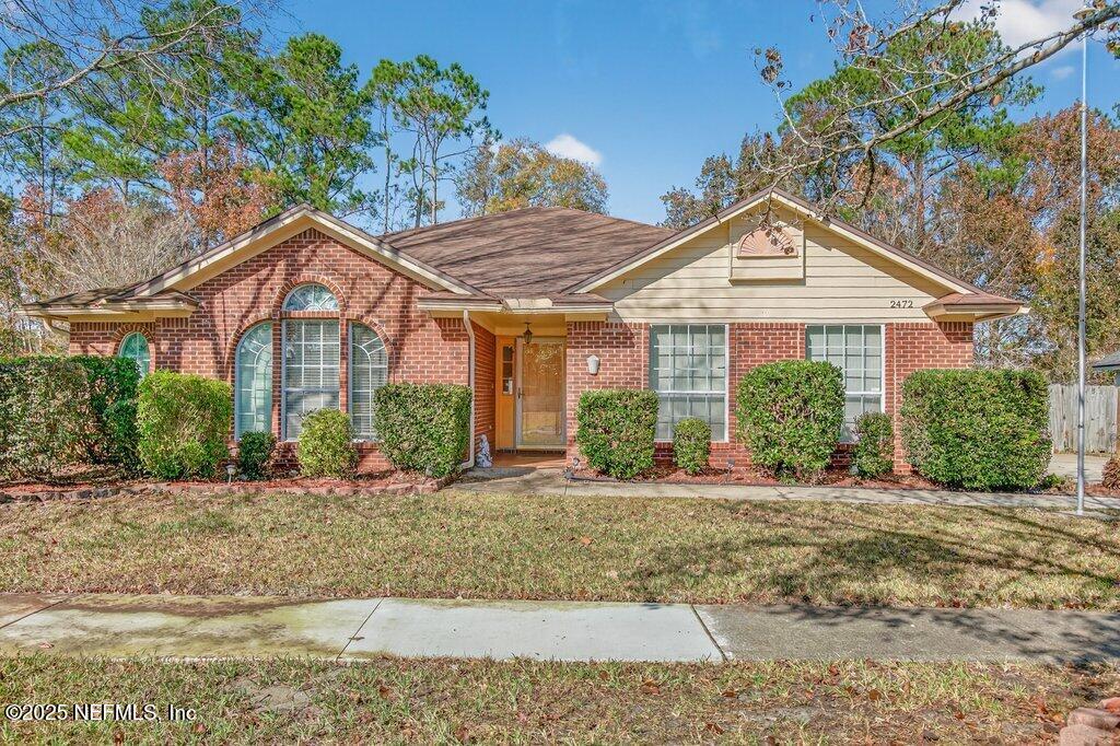 2472 Moon Harbor Way Middleburg, FL 32068 - Photo 50 of 52 a front view of a house with a yard
