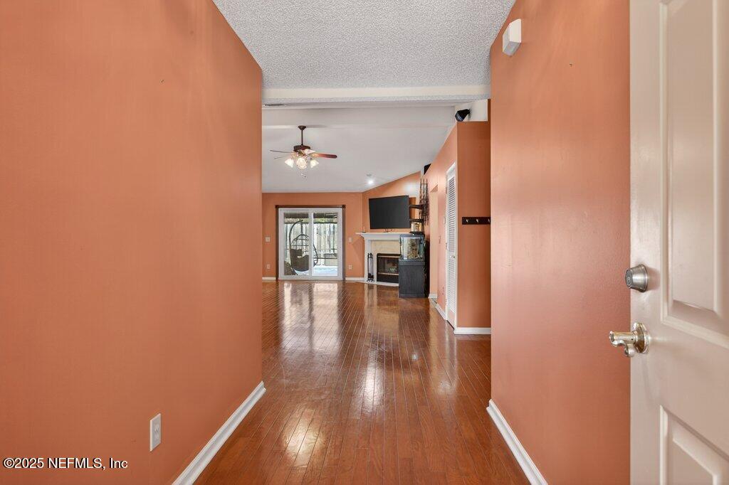 2472 Moon Harbor Way Middleburg, FL 32068 - Photo 8 of 52 a view of a hallway with wooden floor and a bathroom