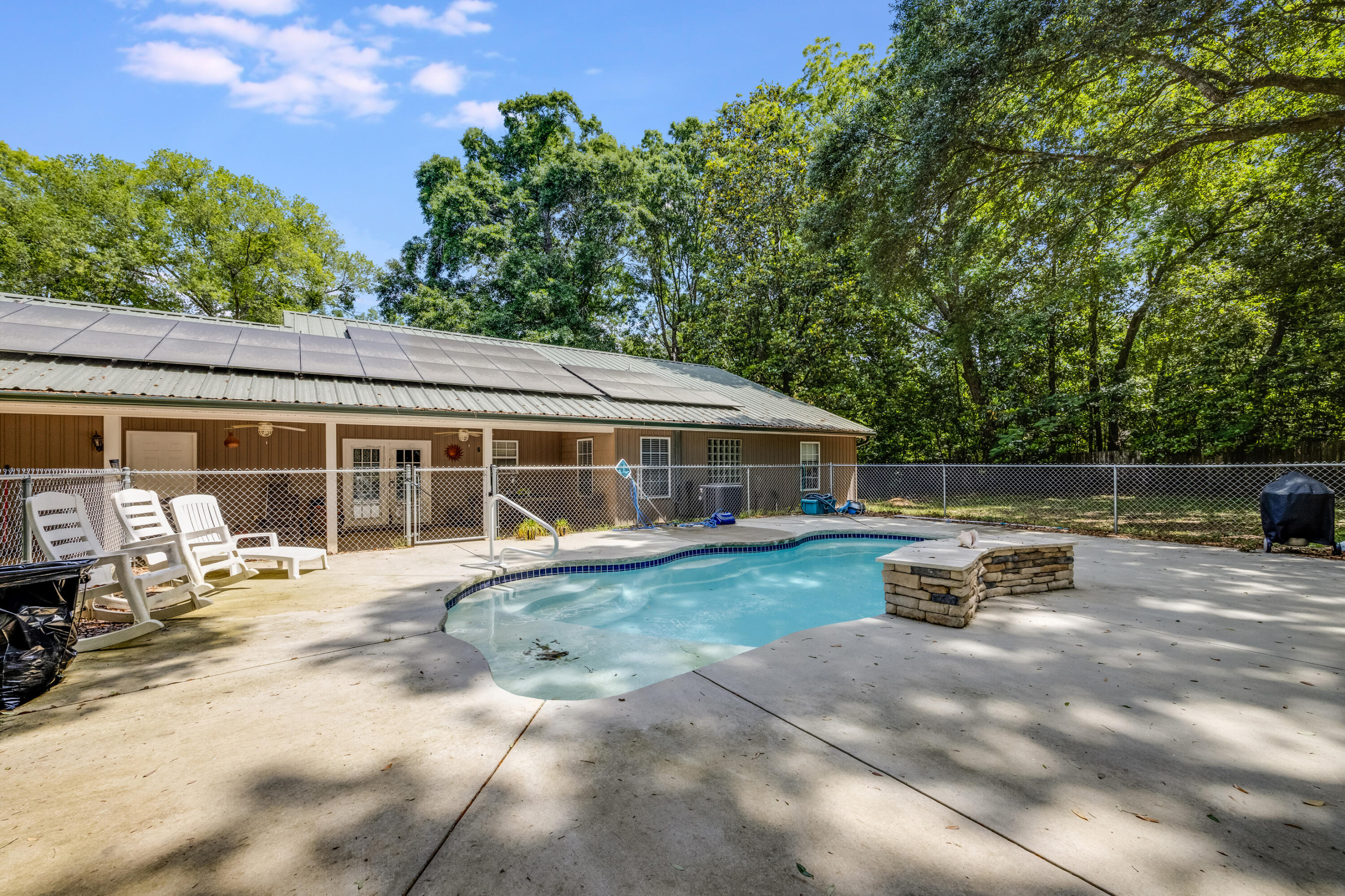 6633 Frank Reeder Road Pensacola, FL 32526 - Photo 13 of 43 a view of a house with backyard sitting area and garden