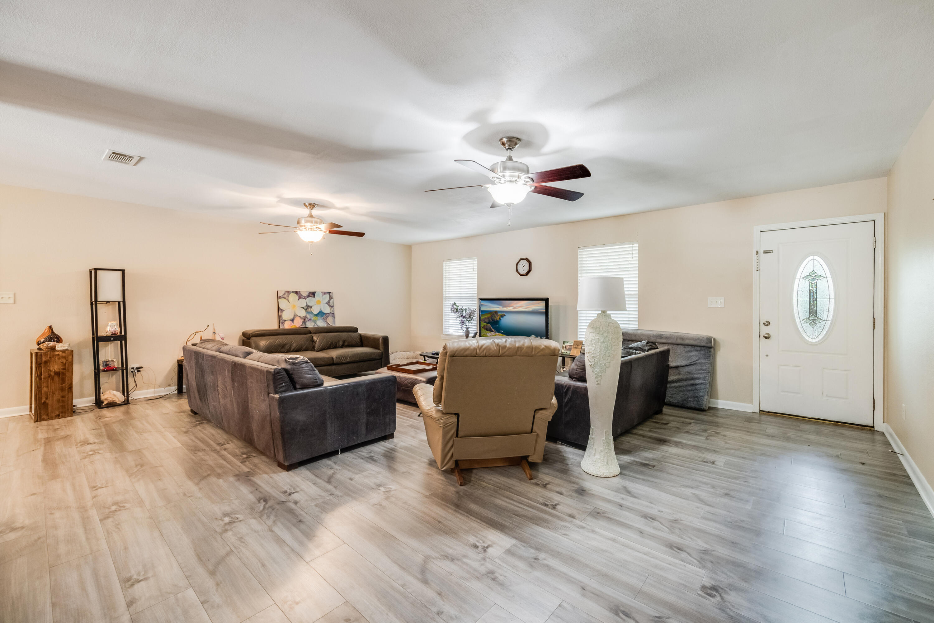 6633 Frank Reeder Road Pensacola, FL 32526 - Photo 20 of 43 a living room with furniture kitchen view and a chandelier