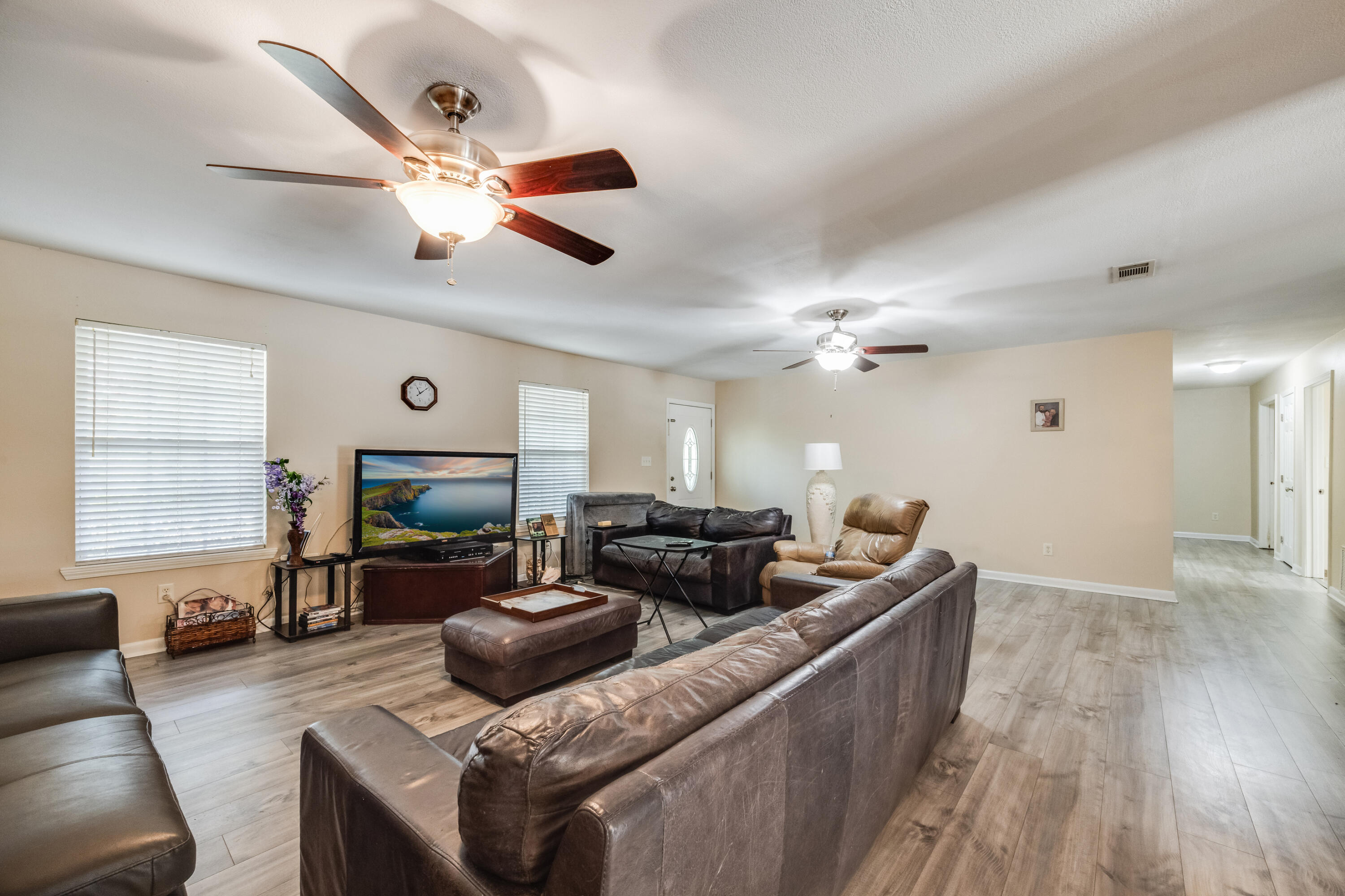 6633 Frank Reeder Road Pensacola, FL 32526 - Photo 21 of 43 a living room with furniture and a flat screen tv