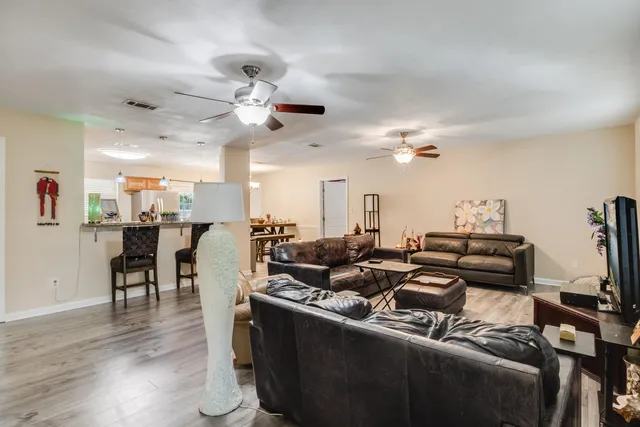 a kitchen with a table chairs refrigerator and microwave