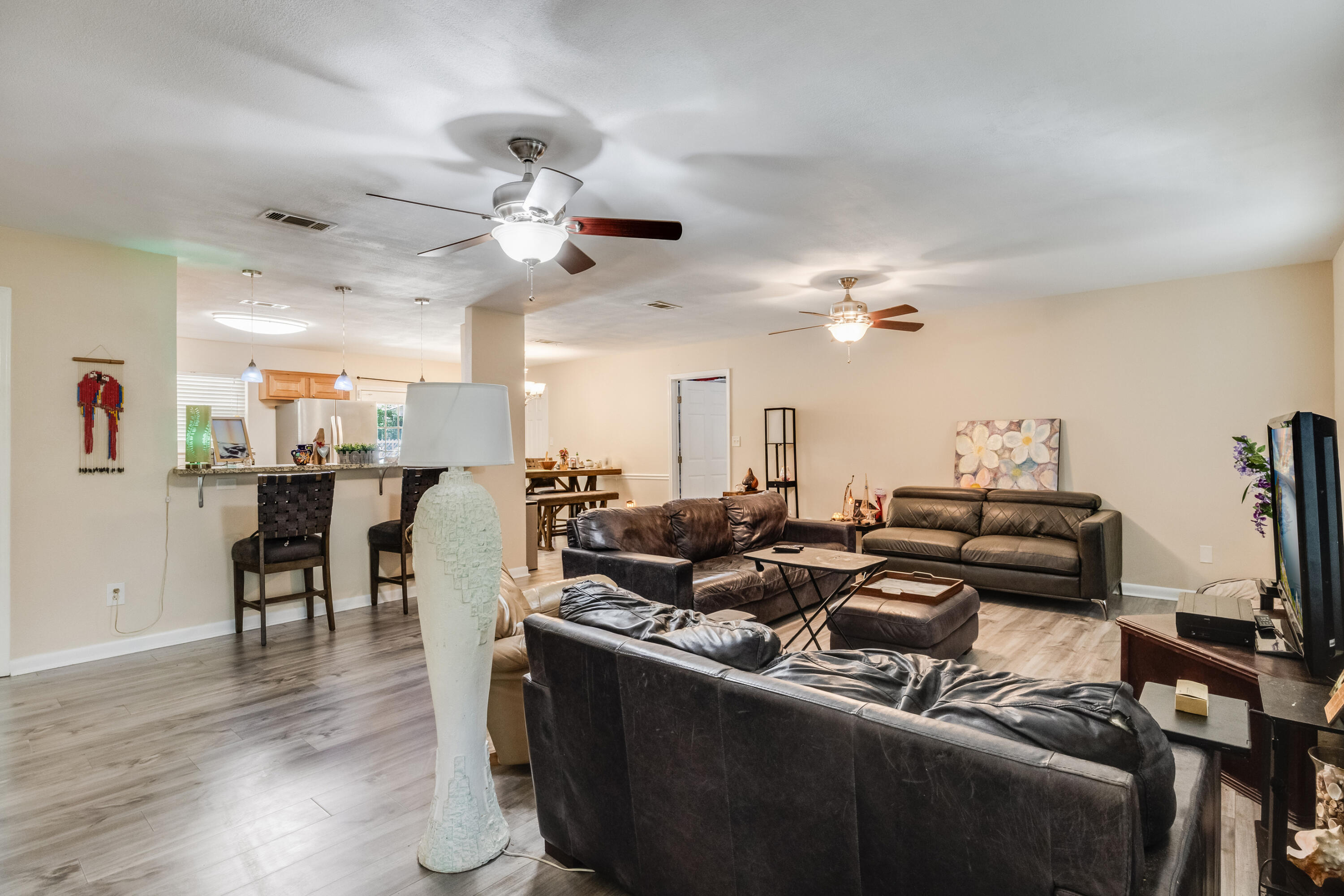6633 Frank Reeder Road Pensacola, FL 32526 - Photo 22 of 43 a living room with furniture kitchen and a chandelier