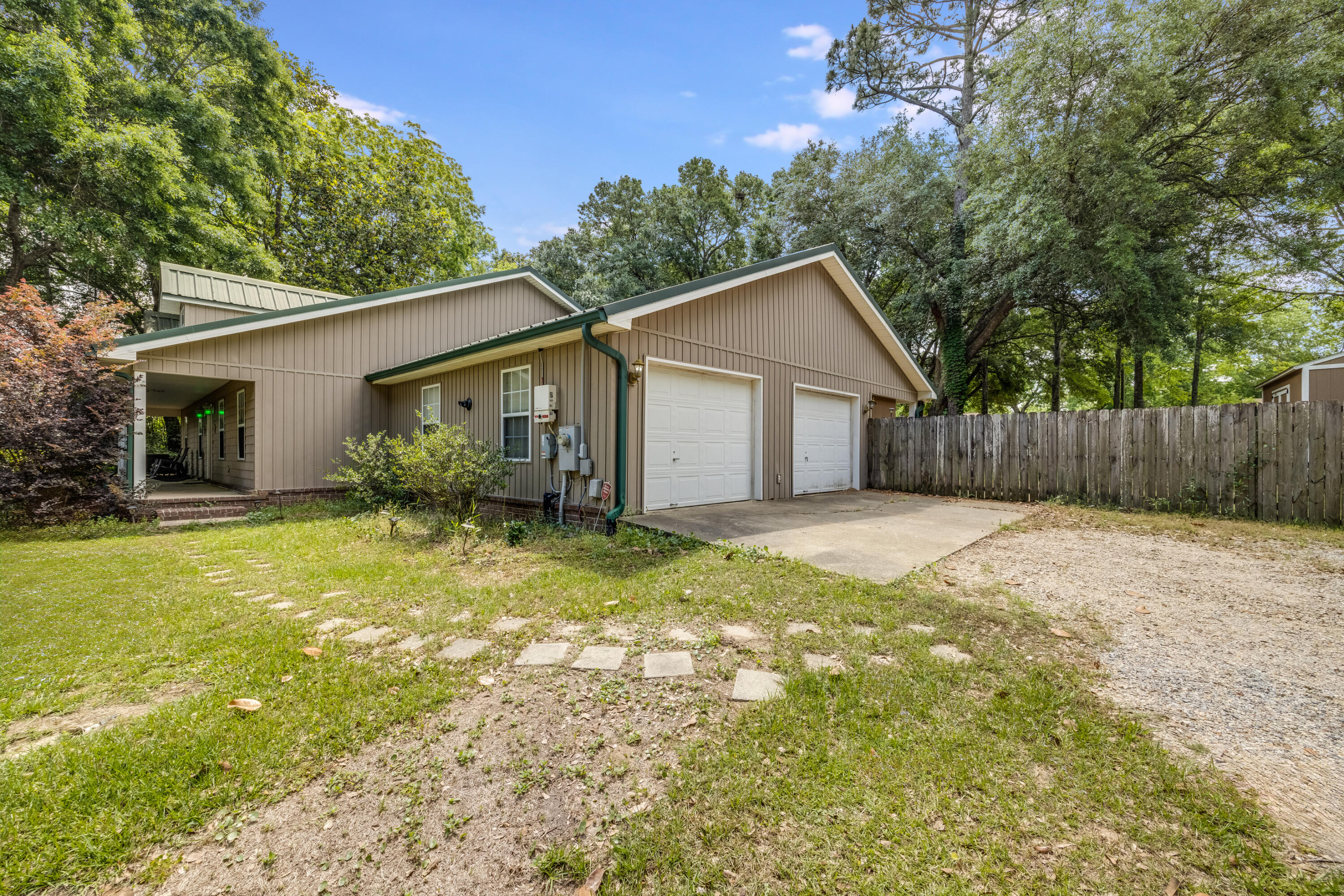 6633 Frank Reeder Road Pensacola, FL 32526 - Photo 6 of 43 a view of a yard in front of a house with large trees