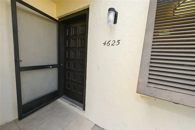 a front view of a house with yard and flowers