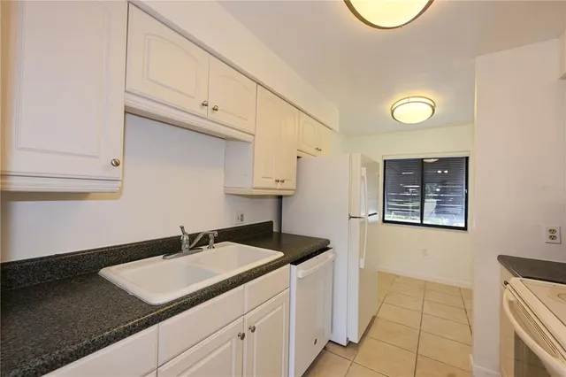 a utility room with sink dryer and washer