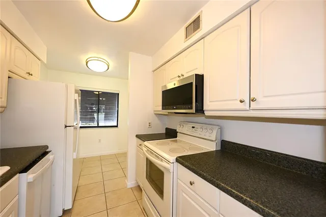a kitchen with a sink and a stove top oven