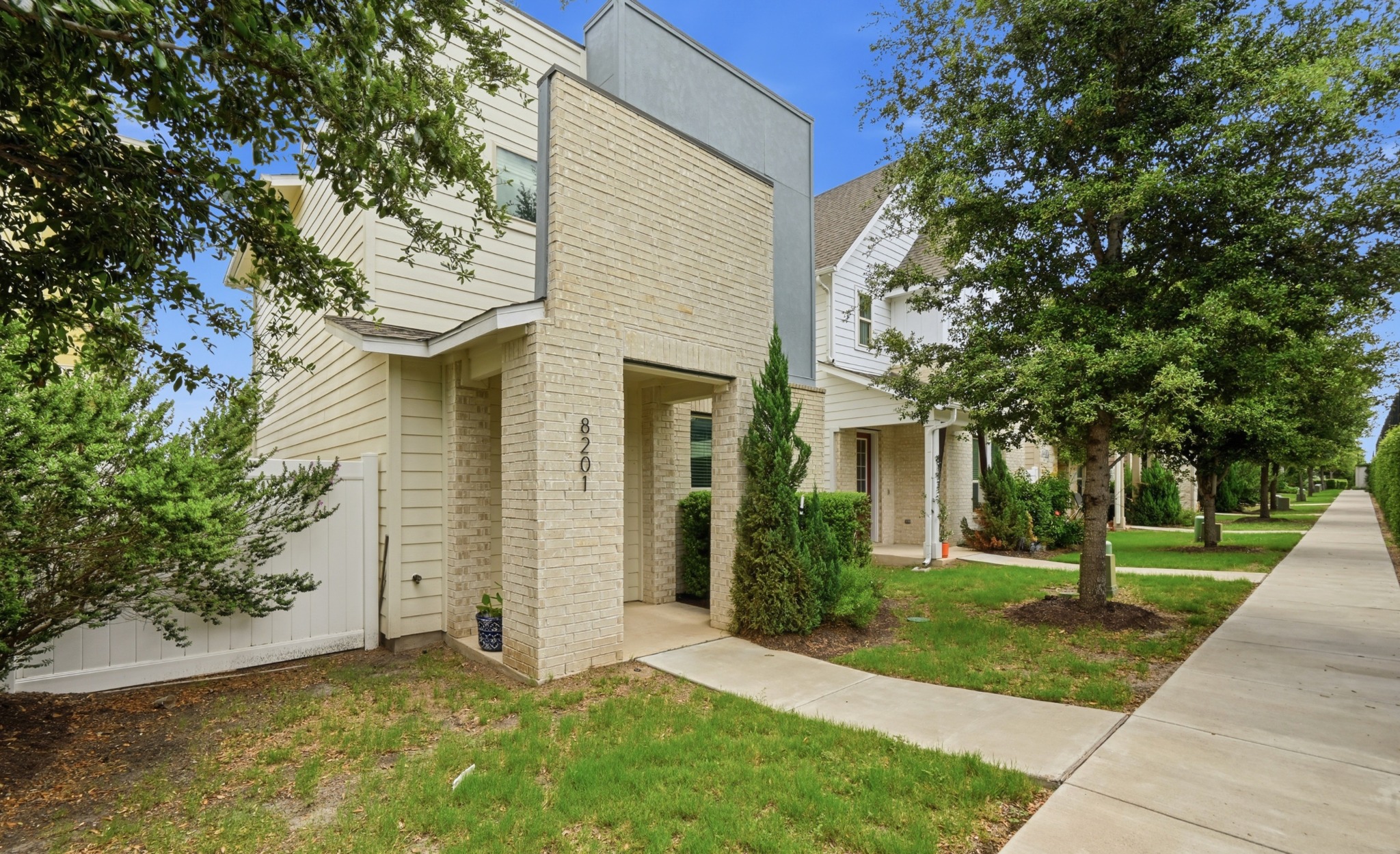 8201 Frida Bend Austin, TX 78744 - Photo 2 of 29 A striking modern facade with brick and siding, featuring a welcoming entry.