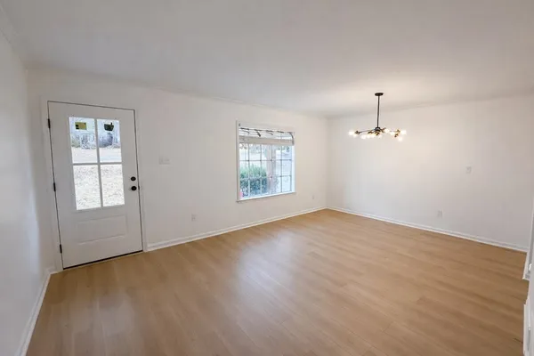 wooden floor in an empty room with a window