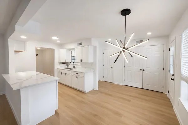 a view of a kitchen with a sink stainless steel appliances and cabinets