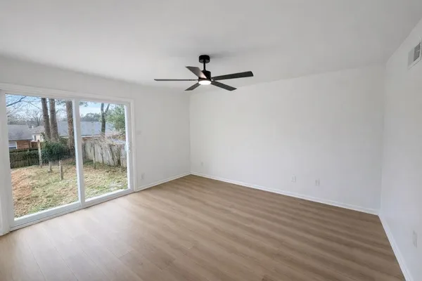 a kitchen with granite countertop a sink and refrigerator