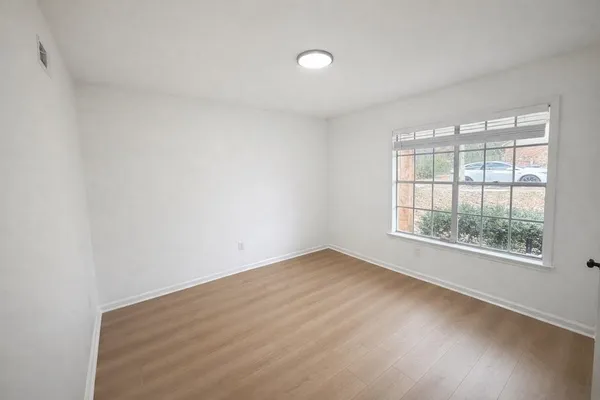 a bathroom with a toilet a sink a mirror and shower