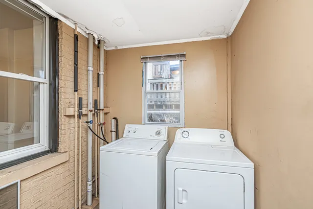 a view of storage and utility room with washer and dryer