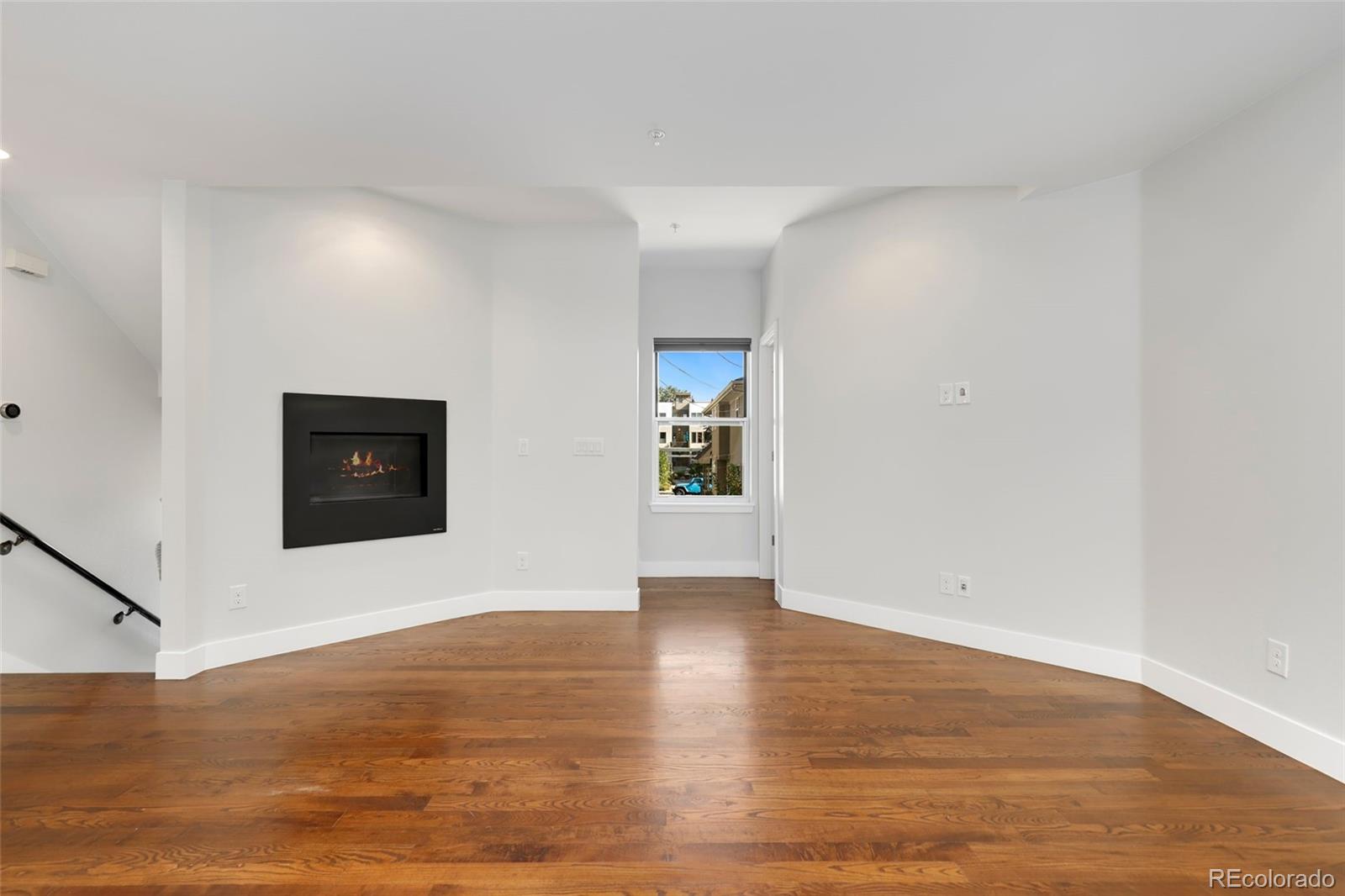 3336 Tejon Street, Unit 4 Denver, CO 80211 - Photo 12 of 35 a view of an empty room with wooden floor and window
