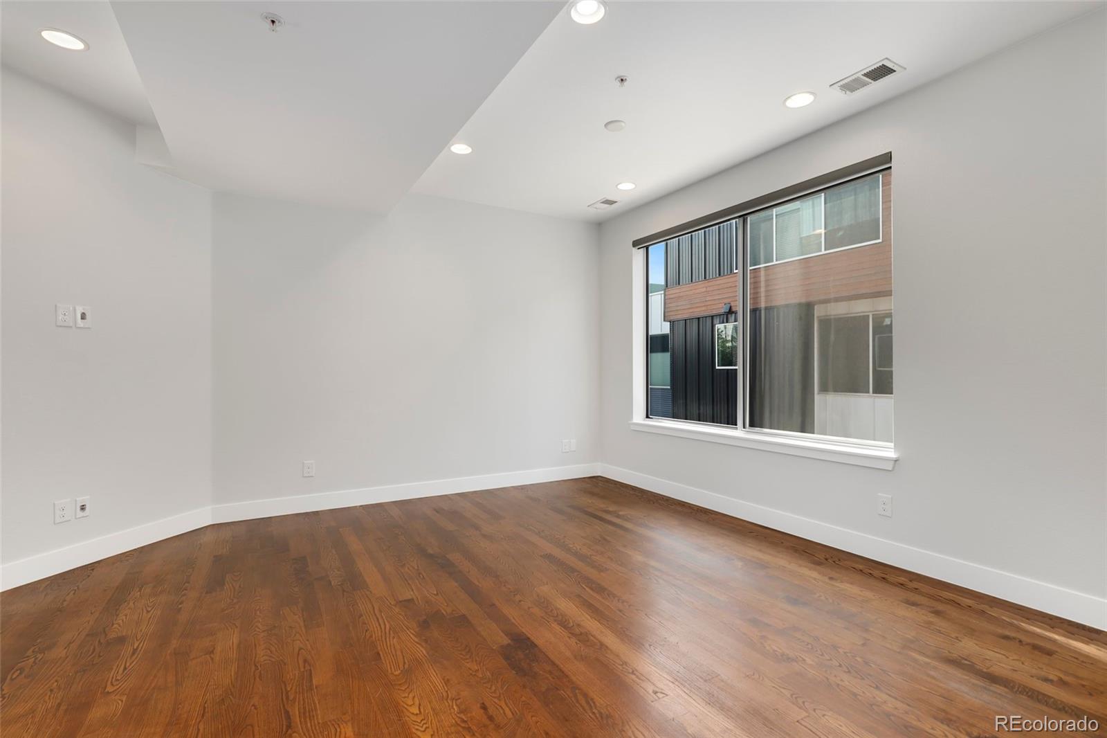3336 Tejon Street, Unit 4 Denver, CO 80211 - Photo 13 of 35 an empty room with wooden floor and windows