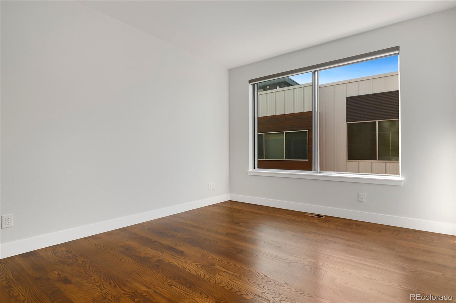 3336 Tejon Street, Unit 4 Denver, CO 80211 - Photo 19 of 35 a view of an empty room with wooden floor and a window