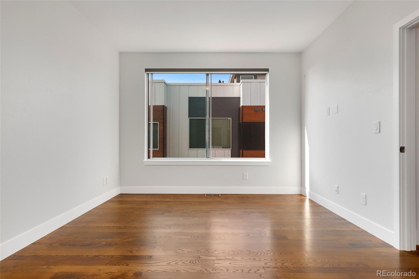 3336 Tejon Street, Unit 4 Denver, CO 80211 - Photo 20 of 35 a view of an empty room with wooden floor and a window