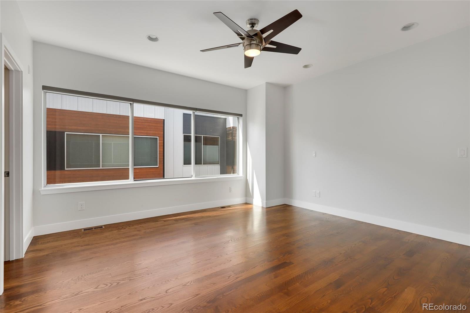 3336 Tejon Street, Unit 4 Denver, CO 80211 - Photo 22 of 35 a view of an empty room with a window and wooden floor