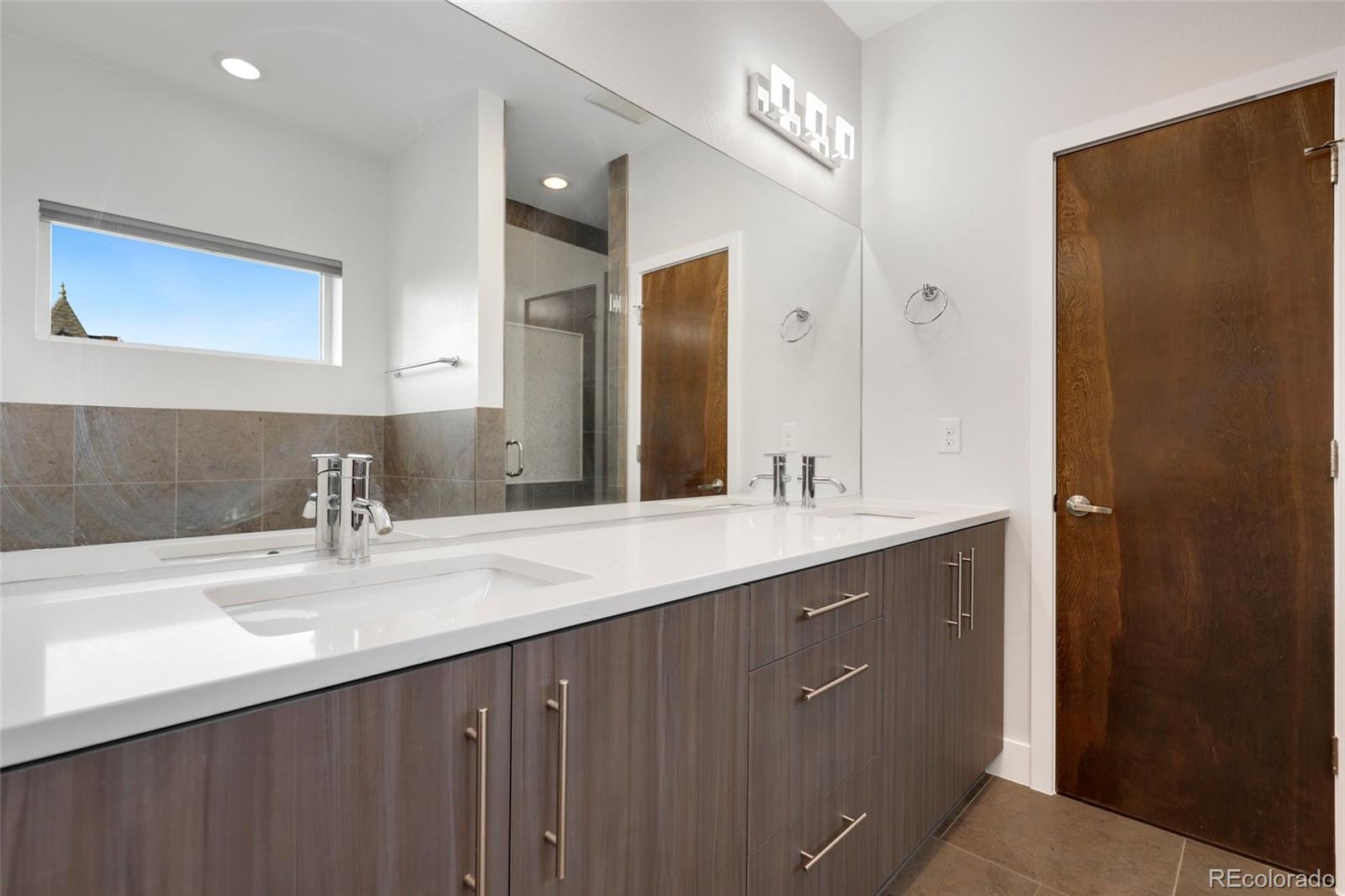 3336 Tejon Street, Unit 4 Denver, CO 80211 - Photo 25 of 35 a bathroom with a double vanity sink and a mirror