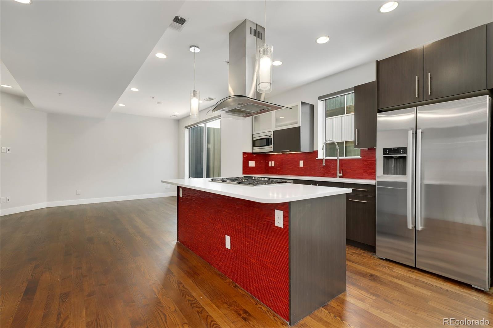 3336 Tejon Street, Unit 4 Denver, CO 80211 - Photo 4 of 35 a kitchen with stainless steel appliances granite countertop a sink a refrigerator and a wooden floors