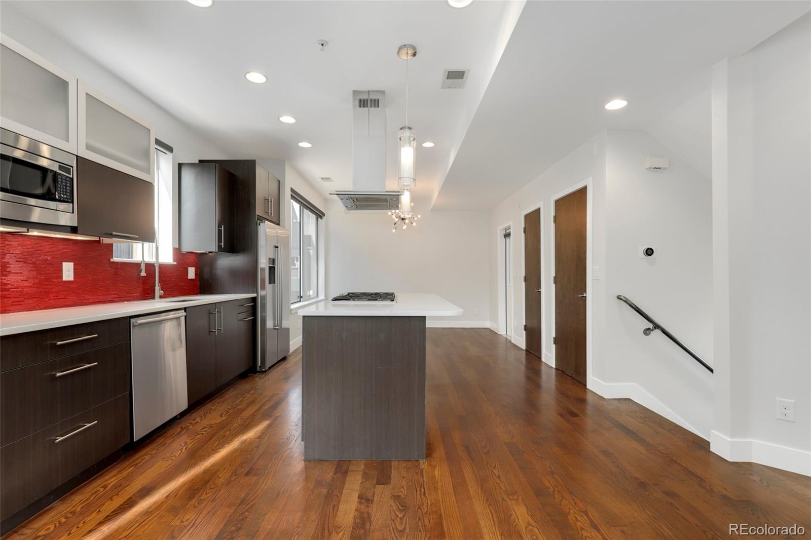 3336 Tejon Street, Unit 4 Denver, CO 80211 - Photo 6 of 35 a kitchen with granite countertop a refrigerator stove top oven and sink