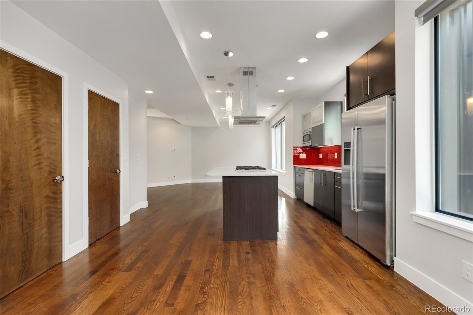 3336 Tejon Street, Unit 4 Denver, CO 80211 - Photo 8 of 35 a open kitchen with kitchen island wooden floor and stainless steel appliances