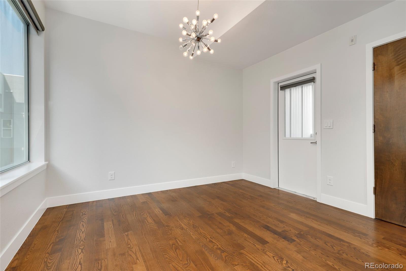 3336 Tejon Street, Unit 4 Denver, CO 80211 - Photo 9 of 35 wooden floor in an empty room with a window