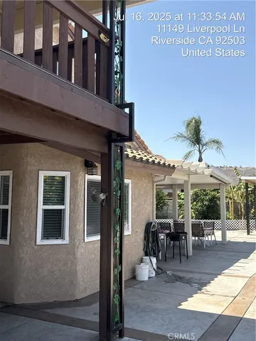 a view of a patio with table and chairs