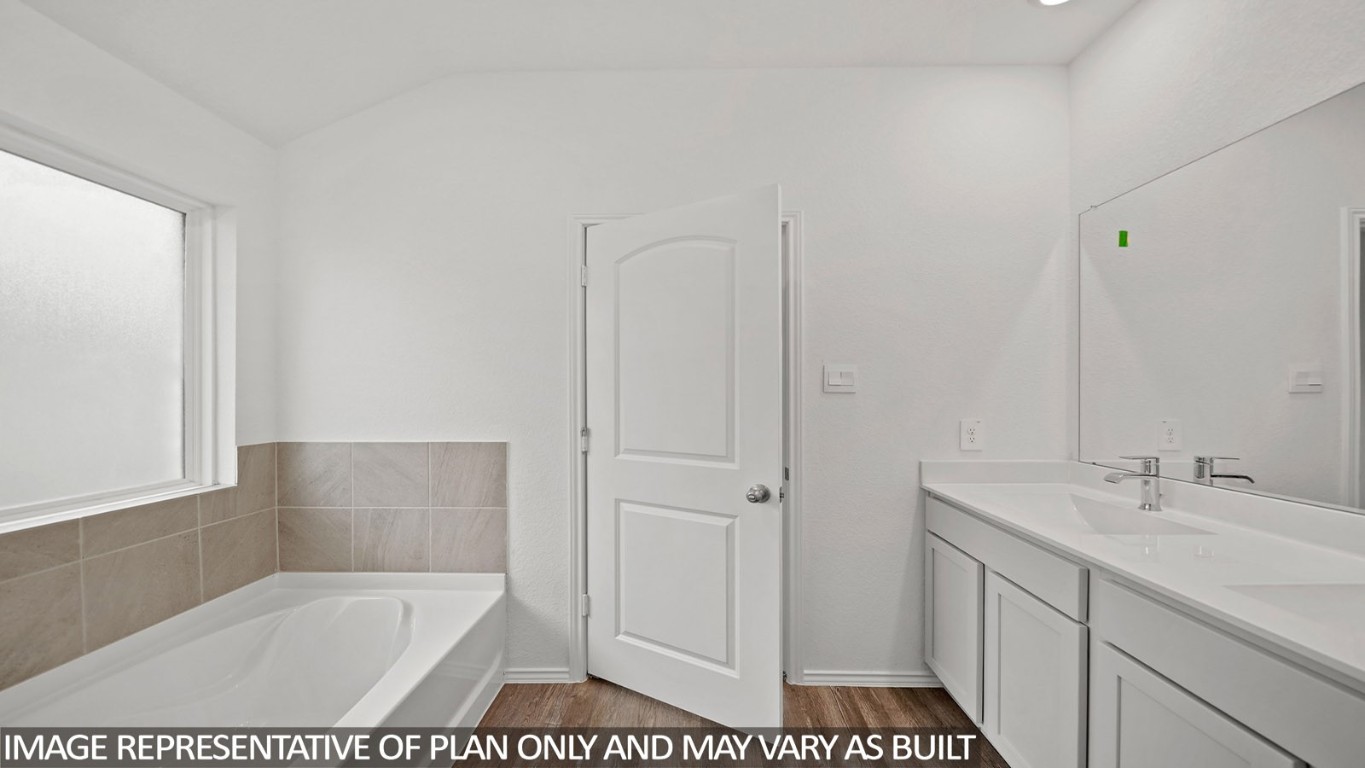 18330 Leibniz Road New Caney, TX 77357 - Photo 11 of 20 a bathroom with a sink a mirror and a bathtub