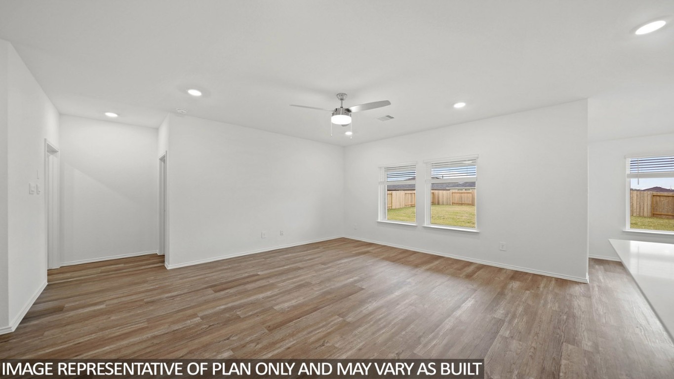 18330 Leibniz Road New Caney, TX 77357 - Photo 6 of 20 an empty room with wooden floor and windows