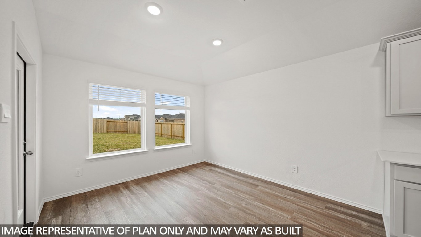 18330 Leibniz Road New Caney, TX 77357 - Photo 7 of 20 an empty room with wooden floor and windows