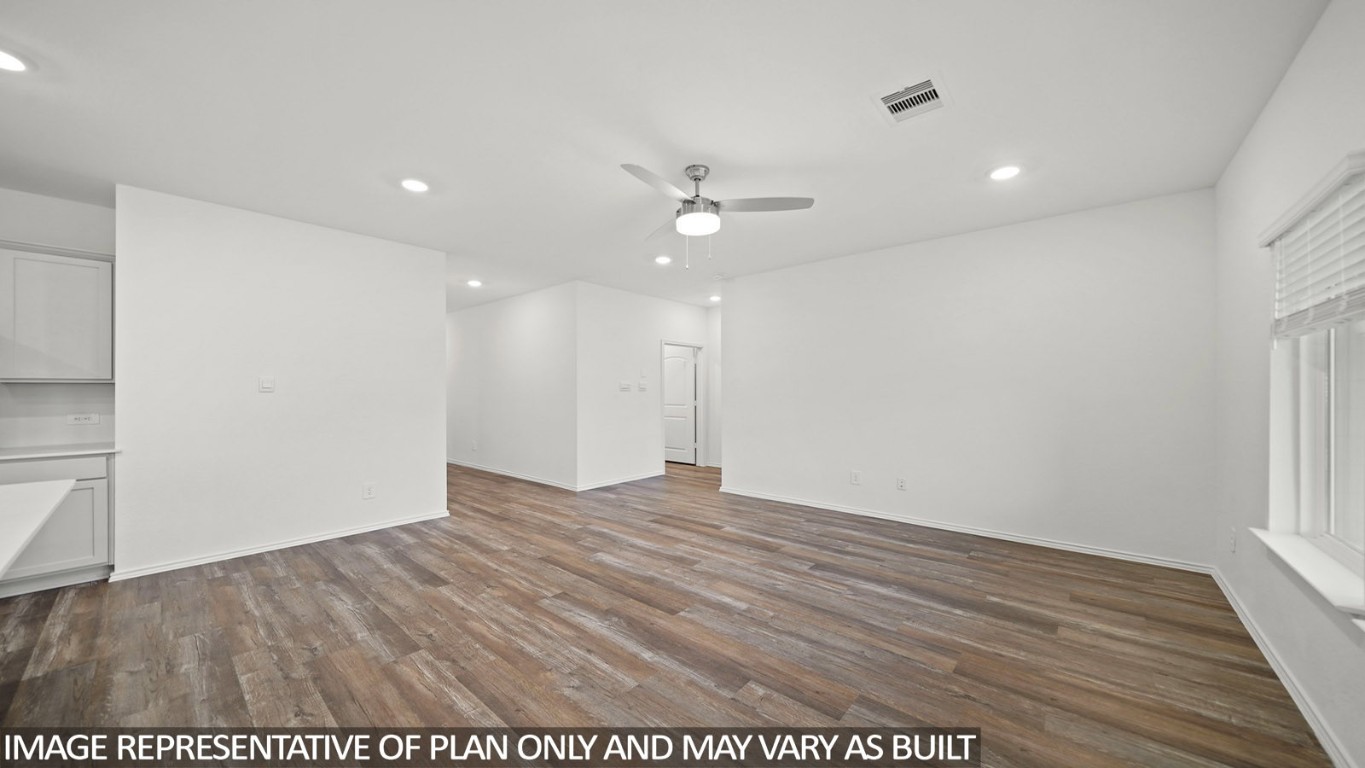 18330 Leibniz Road New Caney, TX 77357 - Photo 8 of 20 an empty room with wooden floor and ceiling fan