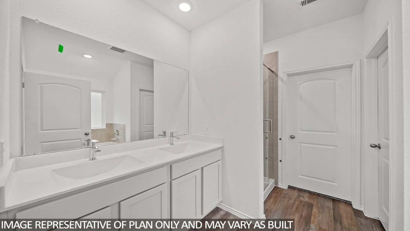 18330 Leibniz Road New Caney, TX 77357 - Photo 10 of 20 a en suite bathroom with a sink and a mirror