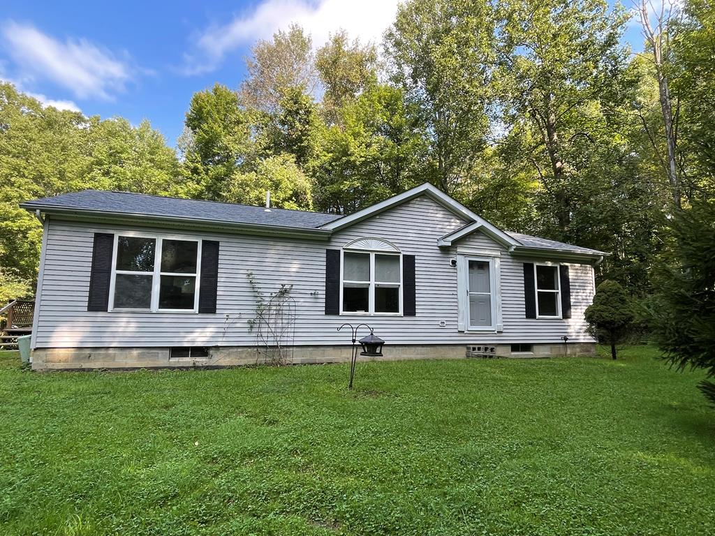 a front view of house with yard and green space