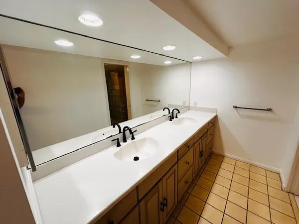 a bathroom with a double vanity sink a and mirror