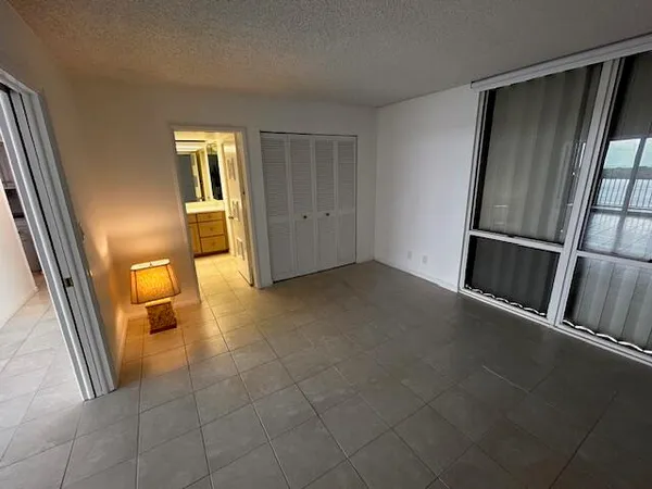 a view of an empty room and a bathroom