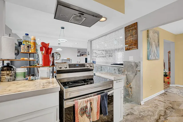 a kitchen with stainless steel appliances granite countertop a stove and a refrigerator